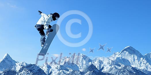 Snowboarder making jump high in clear sky Snowboarder making jump high in clear sky
