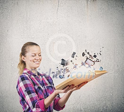 Young woman in casual holding opened book with icons flying out Young woman in casual holding opened book with icons flying out