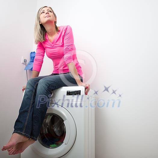 Housework: young woman doing laundry (shallow DOF; color toned image) Housework: young woman doing laundry (shallow DOF; color toned image)