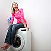 Housework: young woman doing laundry (shallow DOF; color toned image)