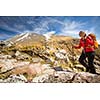 Pretty, young female hiker going uphill