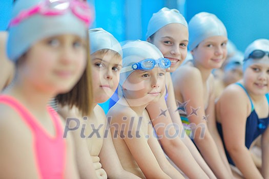 group of happy kids children at swimming pool class learning to swim group of happy kids children at swimming pool class learning to swim