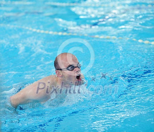health and fitness lifestyle concept with young athlete swimmer recreating on indoor olimpic pool health and fitness lifestyle concept with young athlete swimmer recreating on indoor olimpic pool