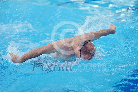 health and fitness lifestyle concept with young athlete swimmer recreating on indoor olimpic pool health and fitness lifestyle concept with young athlete swimmer recreating on indoor olimpic pool
