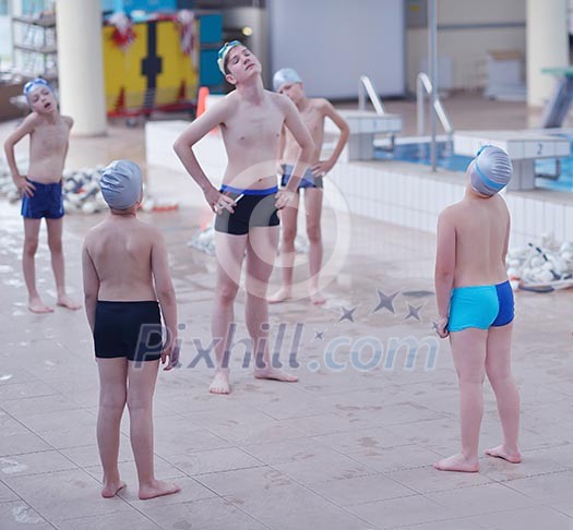 group of happy kids children at swimming pool class learning to swim group of happy kids children at swimming pool class learning to swim