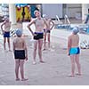 group of happy kids children   at swimming pool class  learning to swim