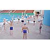 group of happy kids children   at swimming pool class  learning to swim