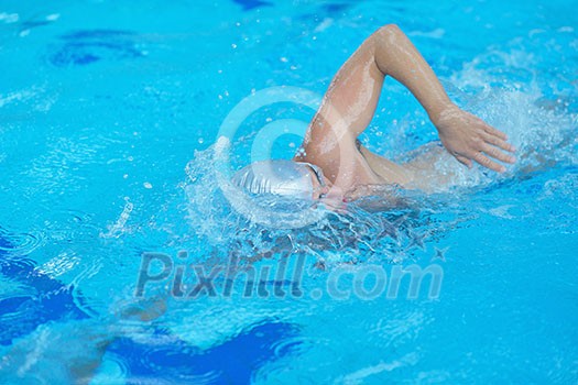 health and fitness lifestyle concept with young athlete swimmer recreating on indoor olimpic pool health and fitness lifestyle concept with young athlete swimmer recreating on indoor olimpic pool