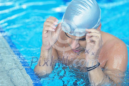 health and fitness lifestyle concept with young athlete swimmer recreating on indoor olimpic pool health and fitness lifestyle concept with young athlete swimmer recreating on indoor olimpic pool