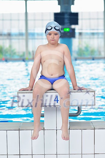 happy little child portrait on swimming school classes and recreation at indoor pool happy little child portrait on swimming school classes and recreation at indoor pool