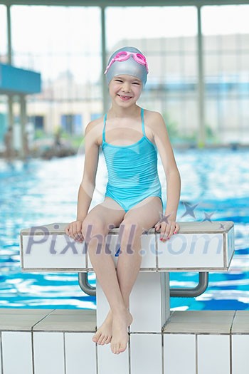 happy little child portrait on swimming school classes and recreation at indoor pool happy little child portrait on swimming school classes and recreation at indoor pool