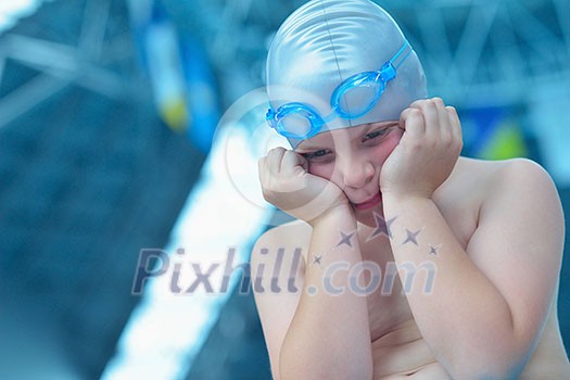 happy little child portrait on swimming school classes and recreation at indoor pool happy little child portrait on swimming school classes and recreation at indoor pool
