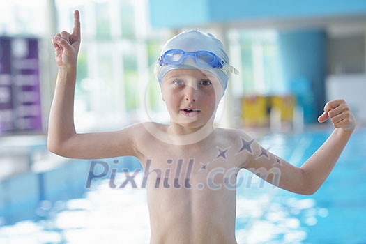 happy little child portrait on swimming school classes and recreation at indoor pool happy little child portrait on swimming school classes and recreation at indoor pool