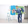 happy young couple paint in green and blue color white wall of their new home