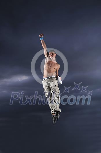 young man dancing and jumping on top of the building young man dancing and jumping on top of the building