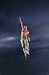 young man dancing and jumping  on top of the building 