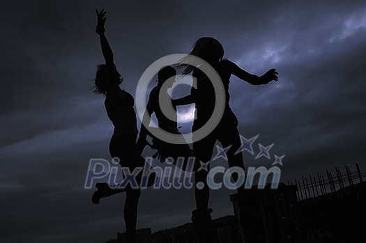group of people jumping in air in night group of people jumping in air in night