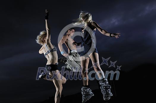 threen teens jumping in air representing disco and pary, joy and fun concept threen teens jumping in air representing disco and pary, joy and fun concept