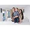 happy young family have fun and relaxing at new home with bright furniture