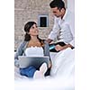 joyful couple relax and work on laptop computer at modern living room indoor home
