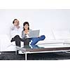 joyful couple relax and work on laptop computer at modern living room indoor home