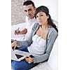 joyful couple relax and work on laptop computer at modern living room indoor home