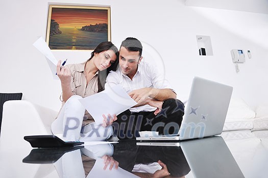joyful couple relax and work on laptop computer at modern living room indoor home joyful couple relax and work on laptop computer at modern living room indoor home