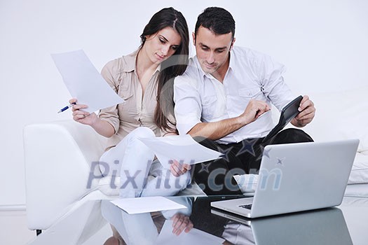 joyful couple relax and work on laptop computer at modern living room indoor home joyful couple relax and work on laptop computer at modern living room indoor home