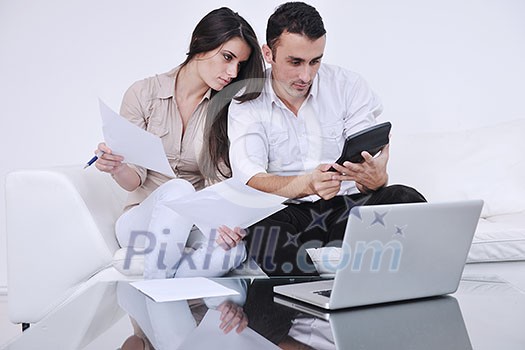 joyful couple relax and work on laptop computer at modern living room indoor home joyful couple relax and work on laptop computer at modern living room indoor home