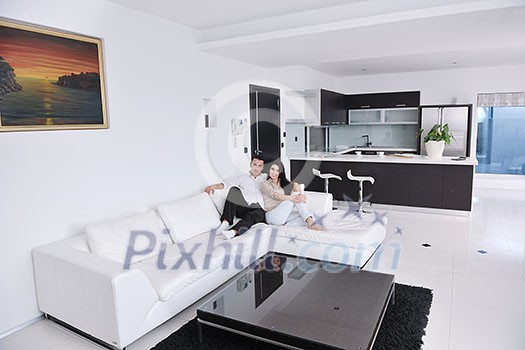 happy young couple relax at modern home living room indoor happy young couple relax at modern home living room indoor