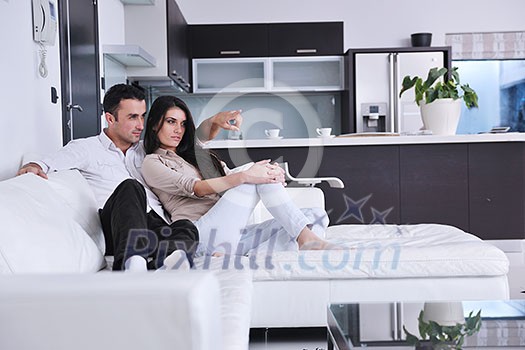 happy young couple relax at modern home living room indoor happy young couple relax at modern home living room indoor