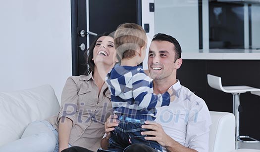 happy young family have fun and relaxing at new home with bright furniture happy young family have fun and relaxing at new home with bright furniture