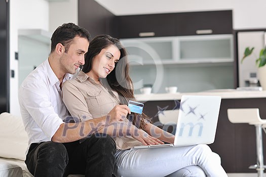 joyful couple relax and work on laptop computer at modern living room indoor home joyful couple relax and work on laptop computer at modern living room indoor home