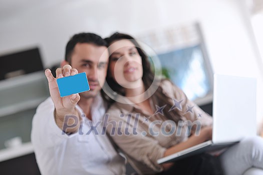 joyful couple relax and work on laptop computer at modern living room indoor home joyful couple relax and work on laptop computer at modern living room indoor home