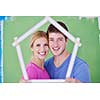 happy young couple paint in green and blue color white wall of their new home