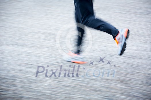 Motion blurred runner's feet in a city environment (panning technique used -> motion blurred image; color toned image) Motion blurred runner's feet in a city environment (panning technique used -> motion blurred image; color toned image)
