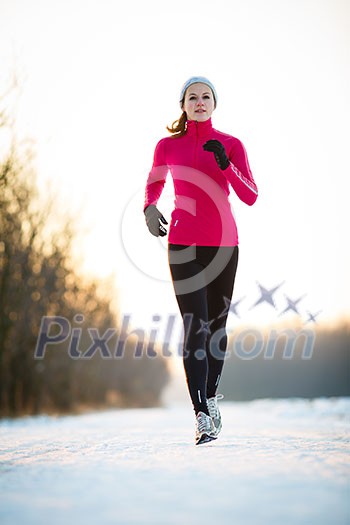 Winter running - Young woman running outdoors on a cold winter day Winter running - Young woman running outdoors on a cold winter day