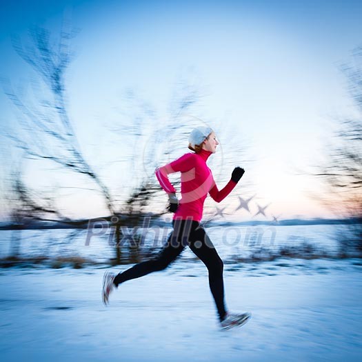 Winter running - Young woman running outdoors on a cold winter day (motion blurred image, color toned image) Winter running - Young woman running outdoors on a cold winter day (motion blurred image, color toned image)