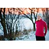 Winter running - Young woman running outdoors on a cold winter day