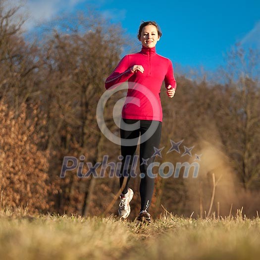 Young woman running outdoors on a lovely sunny winter/fall day Young woman running outdoors on a lovely sunny winter/fall day