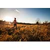 Young woman running outdoors on a lovely sunny winter/fall day (motion blurred image)