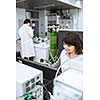 Portrait of a female researcher doing research in a lab (shallow DOF; color toned image)