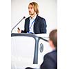 Handsome young man giving a speech at a conference