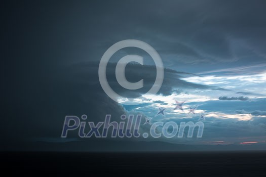 Gathering storm clouds in a vast landscape