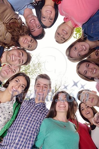 Happy smiling group of young friends staying together outdoor in the park Happy smiling group of young friends staying together outdoor in the park