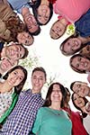 Happy smiling group of young friends staying together outdoor in the park