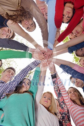 Happy smiling group of young friends staying together outdoor in the park Happy smiling group of young friends staying together outdoor in the park