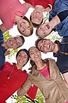 Happy smiling group of young friends staying together outdoor in the park