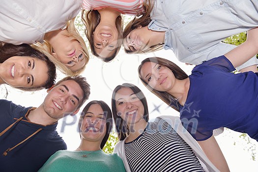 Happy smiling group of young friends staying together outdoor in the park Happy smiling group of young friends staying together outdoor in the park