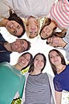 Happy smiling group of young friends staying together outdoor in the park